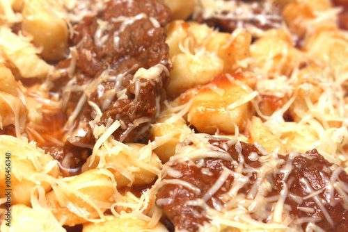Bolognese gnocchi with grated cheese. Italian food. gnocchi with ground meat, tomato sauce and grated cheese. food details. gnocchi background.