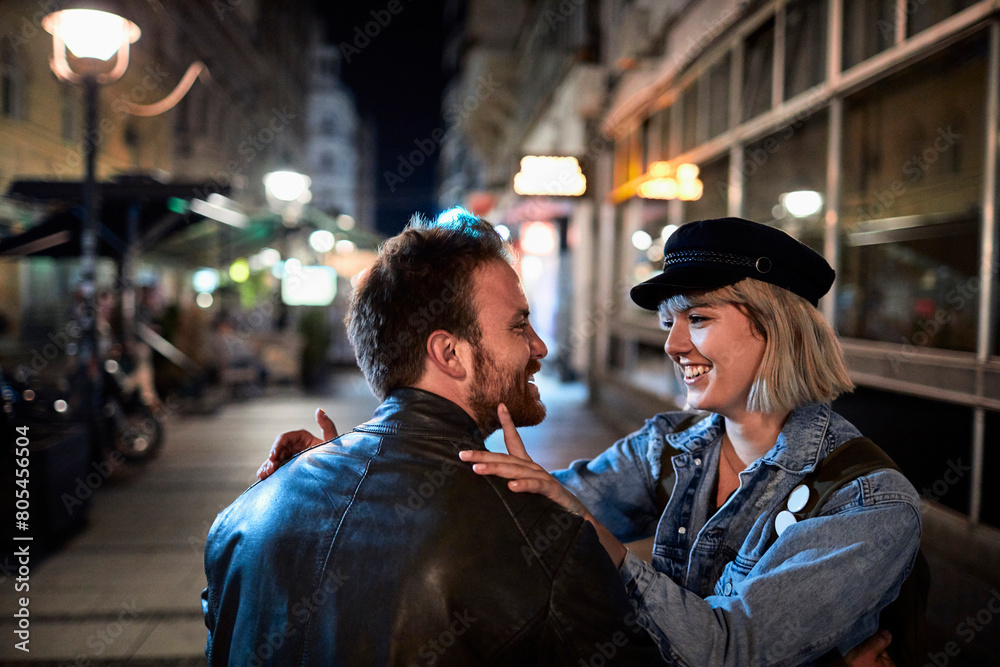 Loving couple enjoying a romantic evening stroll in the city Loving couple enjoying a romantic evening stroll in the city