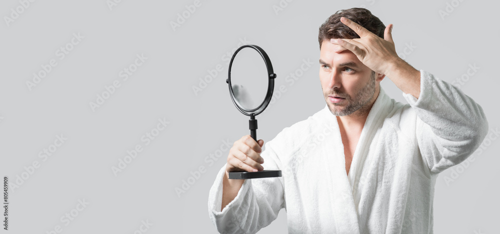 Banner with copy space of man touching chin and skin. Handsome man touching face in front of the mirror in bath. Perfect skin. Man cosmetic, skin treatment. Hygiene and skin care male face. Banner with copy space of man touching chin and skin. Handsome man touching face in front of the mirror in bath. Perfect skin. Man cosmetic, skin treatment. Hygiene and skin care male face.