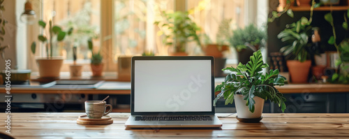 workspace with a laptop and plants in the background © Arrseman