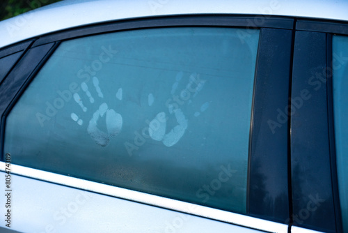 Intimate relationships in the car.Love is in the back seat.A fogged-up car window with handprints.