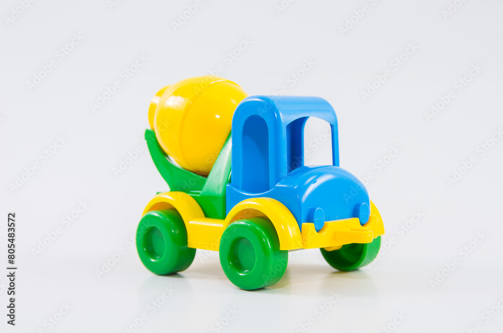 Plastic toy multi-colored truck on a white background. Plastic toy multi-colored truck on a white background.