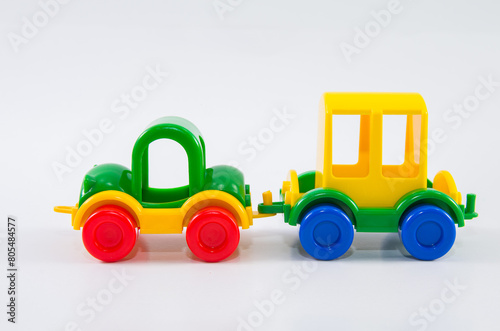 Plastic toy car with travel trailer.