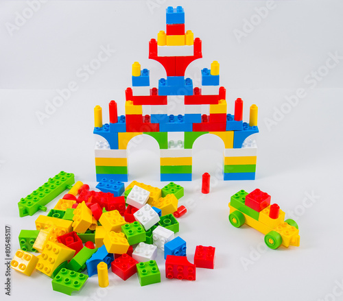 Children's plastic multi-colored construction set on a white background.