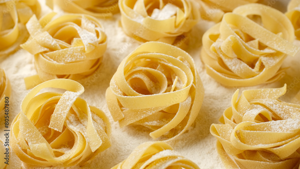 Raw dry pasta fettuccine in flour Raw dry pasta fettuccine in flour
