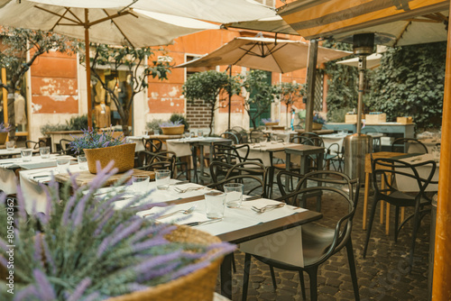 Photography A charming outdoor dining area adorned with tables, chairs, and colorful umbrell