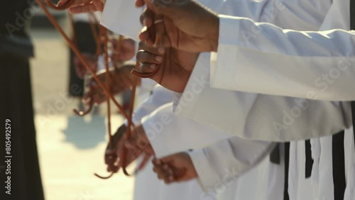 Traditional Emirati Al Ayala male dance, cultural UAE heritage, hands in frame