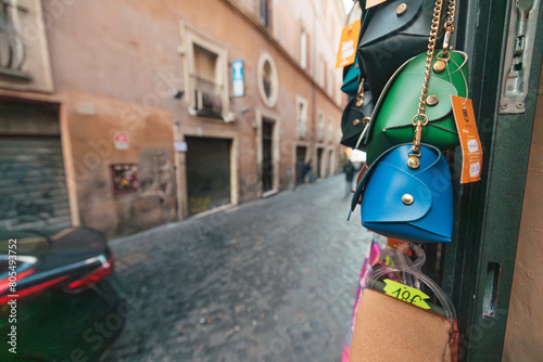 A colorful array of purses hang elegantly on a building, swaying gently in the breeze, creating a unique and eye-catching display against the urban backdrop photo