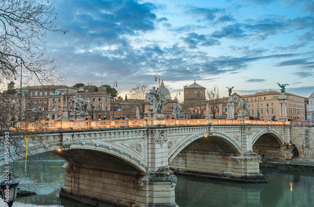Naklejka premium A picturesque scene of a bridge gracefully stretching over a tranquil body of water, framed by the backdrop of urban buildings standing tall in the distance