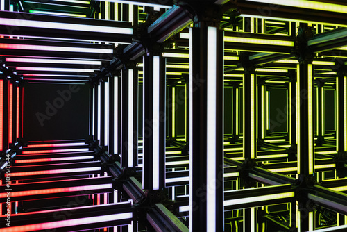 Futuristic neon red yellow white light cube art installation. Technology cyber cube, Sci fi shape. Abstract conceptual background with colorful neon cubes.
