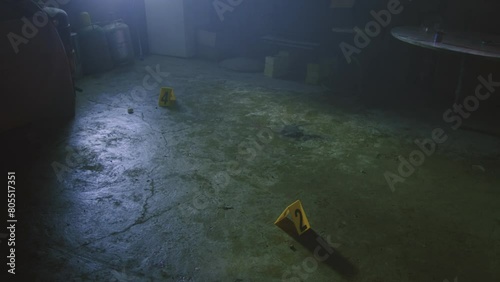 Criminal investigators wearing protective suits and face masks working at a crime scene indoors
