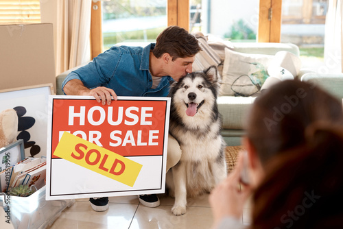 Couple, happy and kiss dog while moving into new home, investment and relocation. Real estate, bond and celebration with pet for house sale, man and woman in living room or pet friendly apartment photo