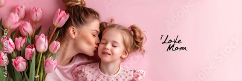 mother with bouquet of pink tulips kissing her child daughter with pink background and space to write Mother's Day #805521115