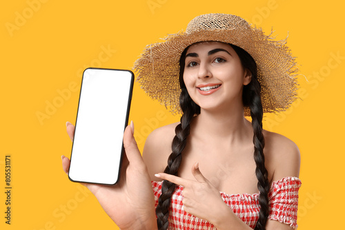 Young happy woman pointing ...