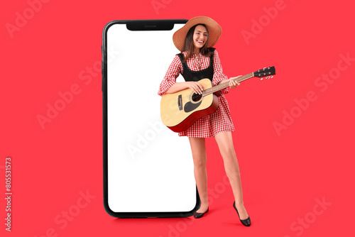 Young woman playing guitar ...