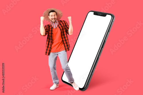 Happy young man on red back...