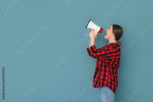 Young woman shouting into m...