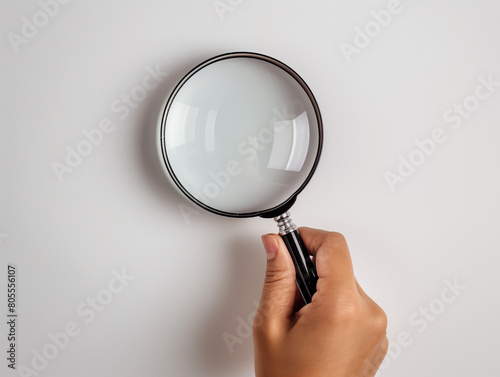 hand holding magnifying glass