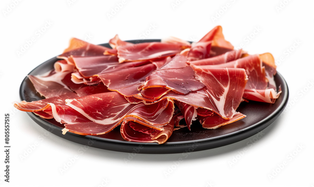 delicious jamon on black plato on a white background close-up