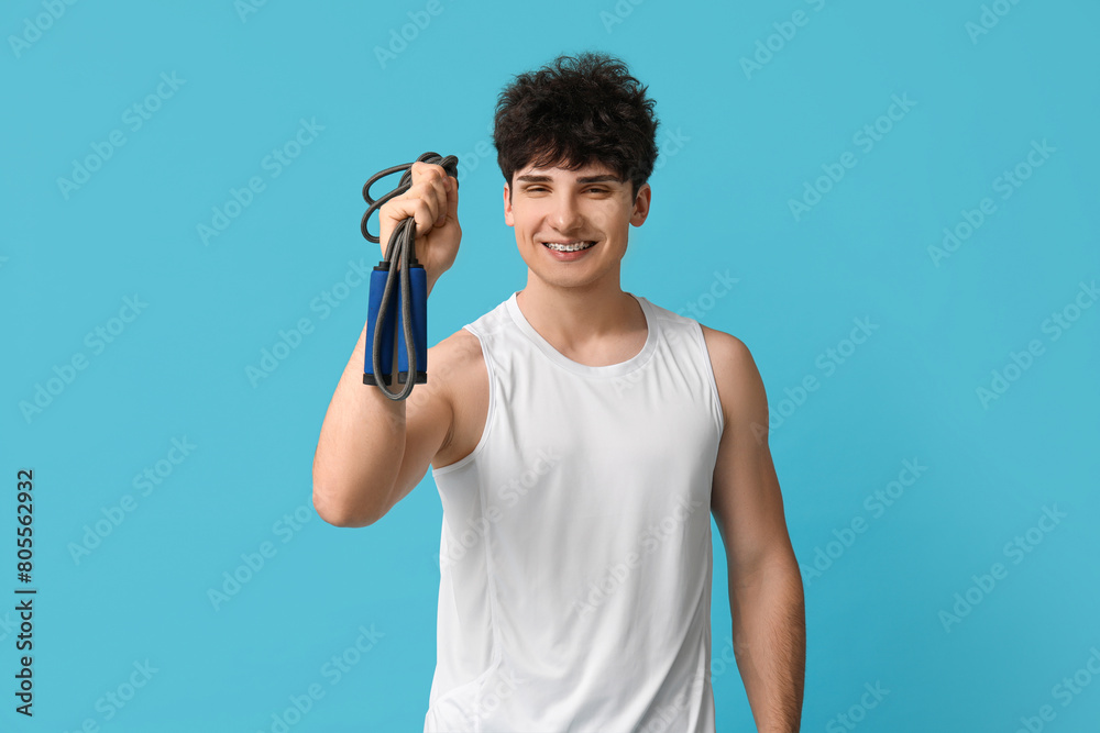 Sporty guy with jumping rope on blue background Sporty guy with jumping rope on blue background