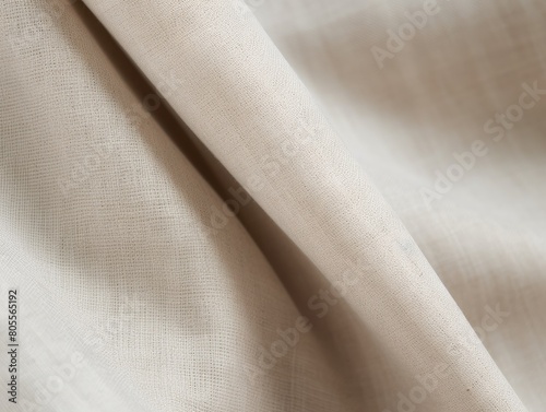 Close-up of a gently draped, soft white linen fabric with visible texture and natural folds.
