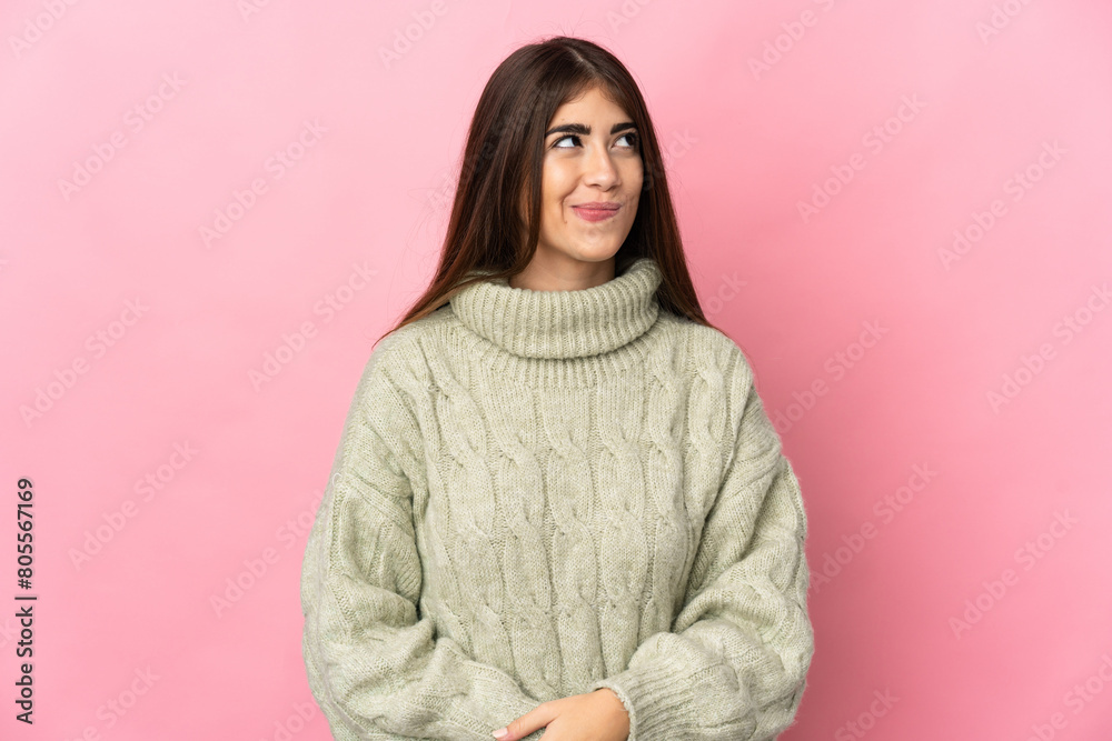 Young caucasian woman isolated on pink background having doubts while looking up Young caucasian woman isolated on pink background having doubts while looking up