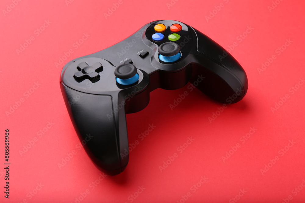 One wireless game controller on red background One wireless game controller on red background