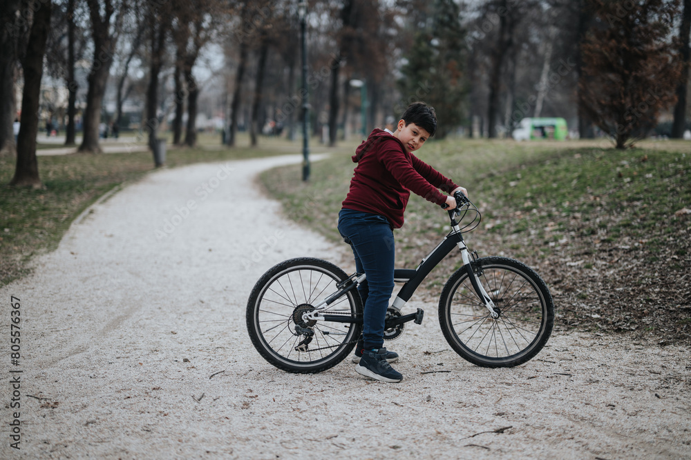 Carefree young boy riding his bicycle in a green park, a scene of healthy childhood lifestyle and joy.