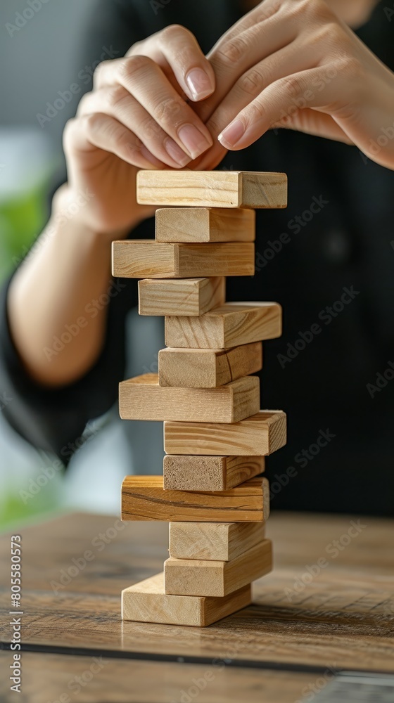Businesswoman Strategically Maneuvering Wooden Blocks for Risk Management and Business Planning Businesswoman Strategically Maneuvering Wooden Blocks for Risk Management and Business Planning