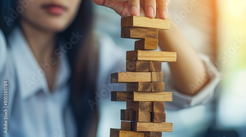 Businesswoman Strategically Maneuvering Wooden Blocks for Risk Management and Business Planning