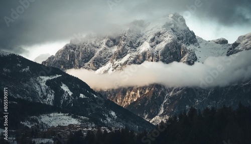 snowcapped mountain covered with clouds and fog trento italy