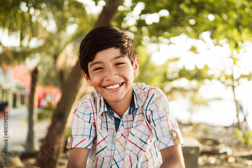 Happy Young Boy Smiling in a Sunny Outdoor Setting