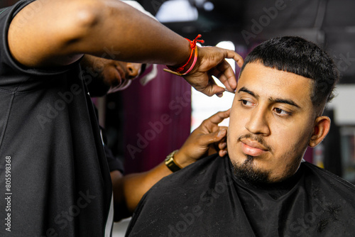 Professional Barber Giving a Man a Haircut in Salon