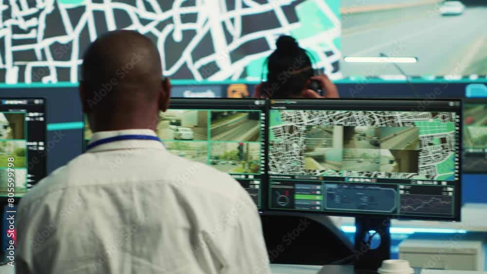 Diverse employees operators tracking delivery cars on satellite navigation map, guiding couriers in the city to avoid traffic and get to the destination. Shipping agency delivering cargo. Camera A. Diverse employees operators tracking delivery cars on satellite navigation map, guiding couriers in the city to avoid traffic and get to the destination. Shipping agency delivering cargo. Camera A.
