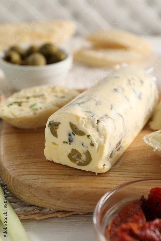 Tasty butter with olives and green onion on table, closeup