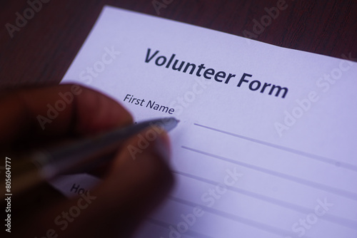 Filling a volunteer form for Non Governmental Organization NGO job photo