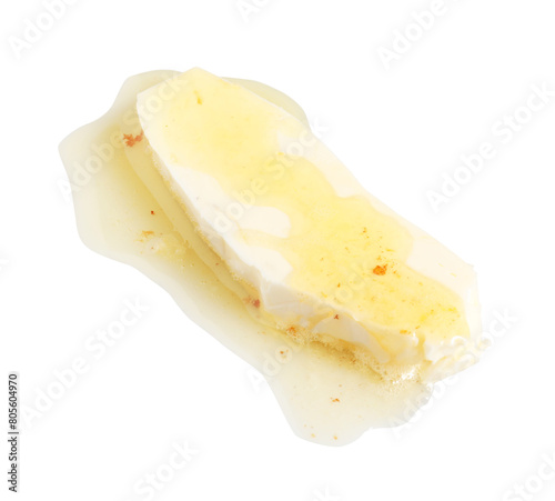 Piece of melting butter on white background