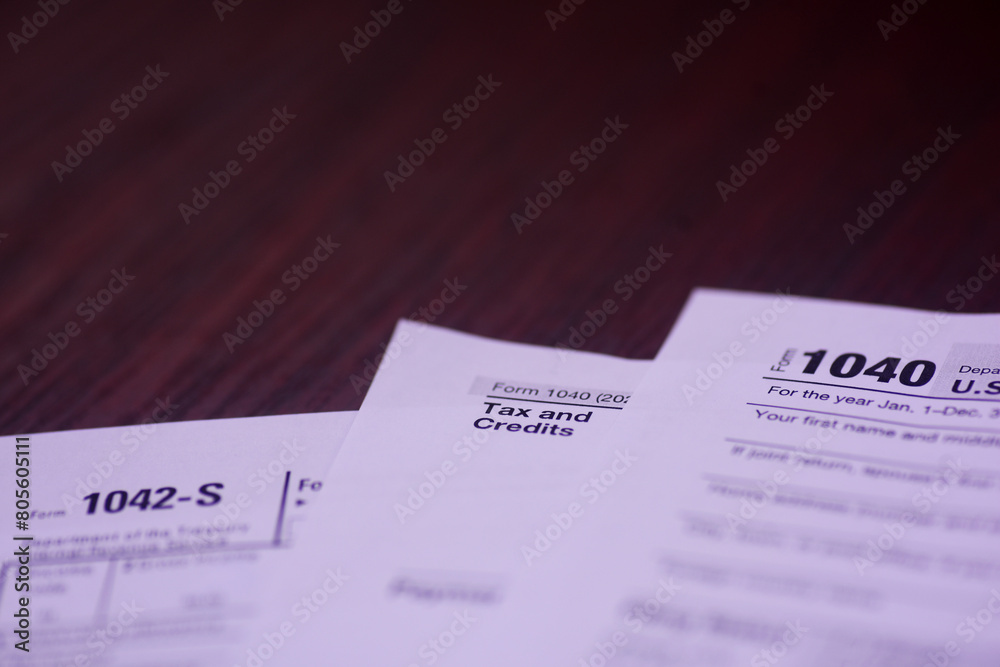 Income tax and credit for spread on an accountant's wooden table Income tax and credit for spread on an accountant's wooden table