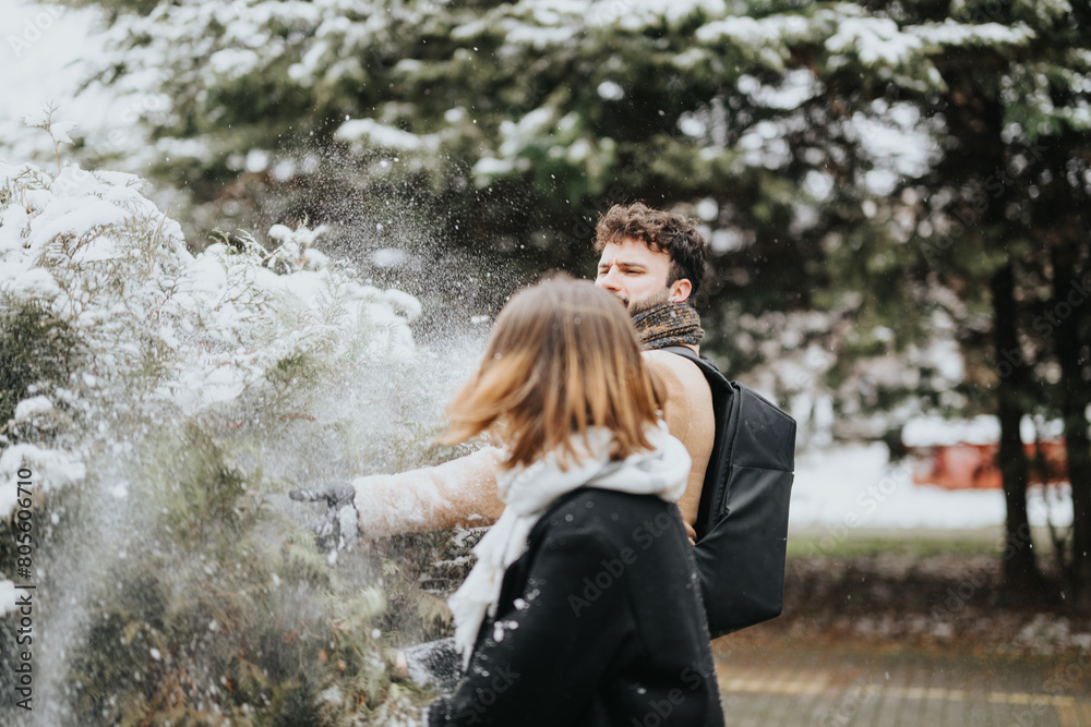 A candid capture of young businesspeople with one pointing at something, both enjoying a snowy day outdoors in an urban environment.