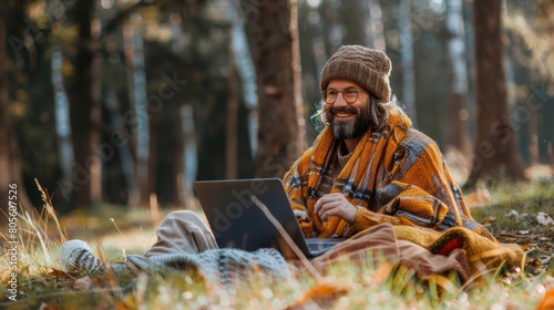 Man Sitting in Field With Laptop