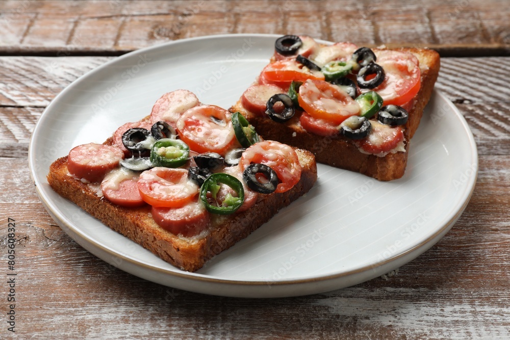 Tasty pizza toasts on wooden table, closeup Tasty pizza toasts on wooden table, closeup