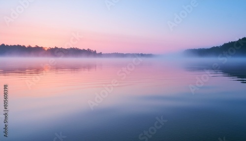 A serene lake at dawn  mist hovering over the water  with a clear sky transitioning