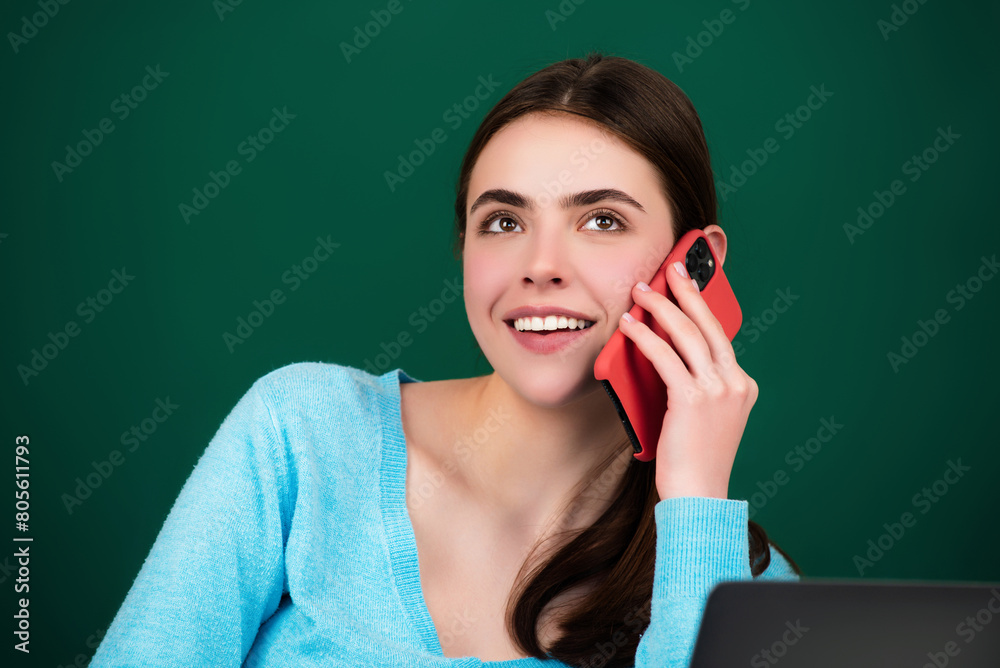 Female student using phone in classroom. School girl chatting on mobile phone near blackboard. Education concept. Lesson and homework in university. Female student using phone in classroom. School girl chatting on mobile phone near blackboard. Education concept. Lesson and homework in university.