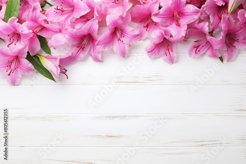 A lush arrangement of pink alstroemeria flowers, with their delicate petals and detailed markings, against a white wooden backdrop. Vibrant Pink Alstroemeria Flowers on White Wooden Surface