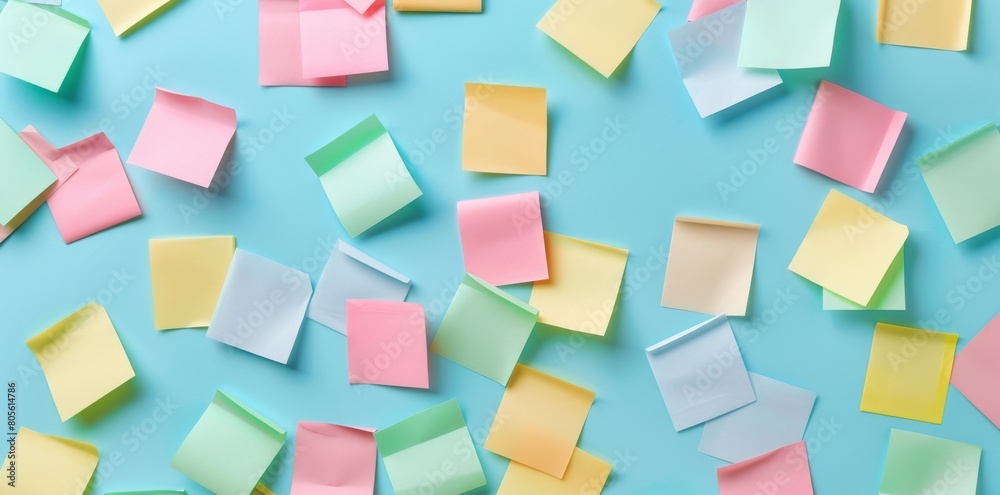 Colorful sticky notes on a light blue background, shown from a top view. Colorful sticky notes on a light blue background, shown from a top view.