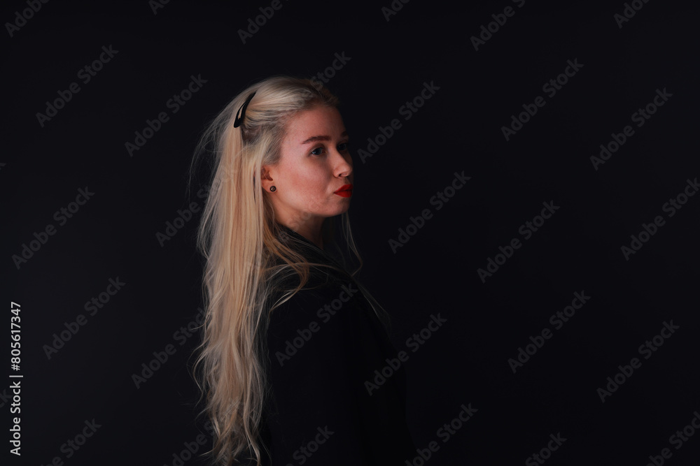 Beautiful young blonde woman in black jacket low key portrait Beautiful young blonde woman in black jacket low key portrait