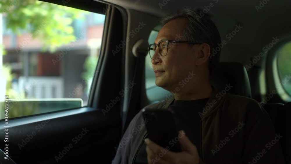 Relaxing moment of Senior old man sitting in car back seats using smartphone play social media with safety belt and look out the window. Grandfather happy in car traveling on the road to destination.
Relaxing moment of Senior old man sitting in car back seats using smartphone play social media with safety belt and look out the window. Grandfather happy in car traveling on the road to destination.