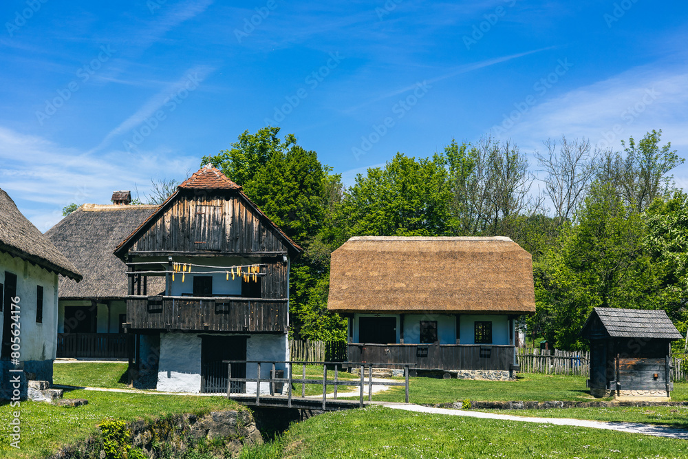 Buildings in etno village in Kumrovec or Kumrovac, home to Josip broz Tito, in northern part of Croata. Old houses on a sunny summer day. Buildings in etno village in Kumrovec or Kumrovac, home to Josip broz Tito, in northern part of Croata. Old houses on a sunny summer day.