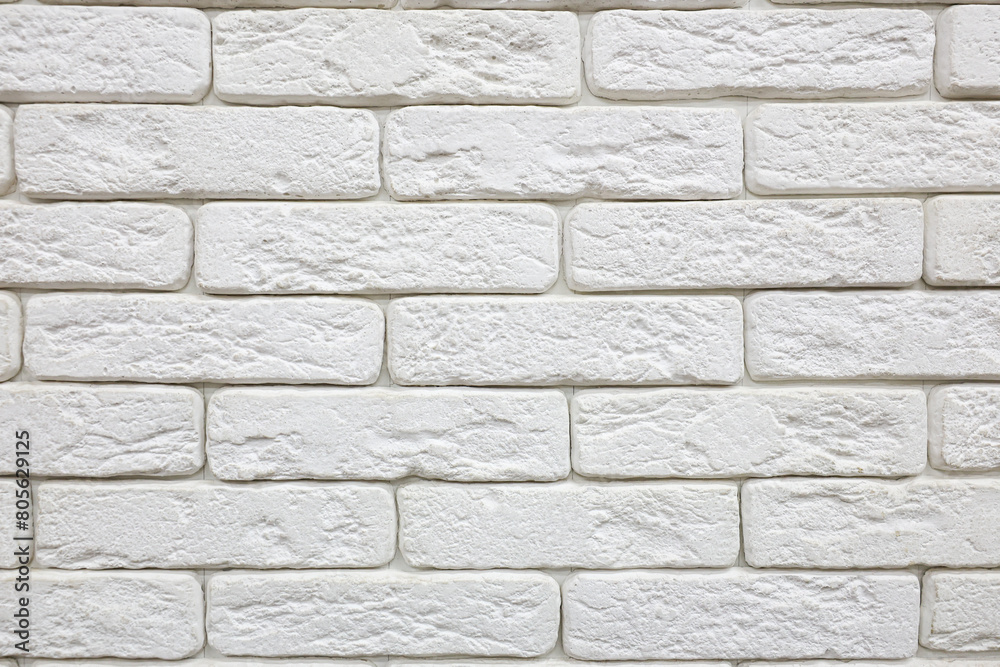 Obraz premium A white brick wall with rough texture