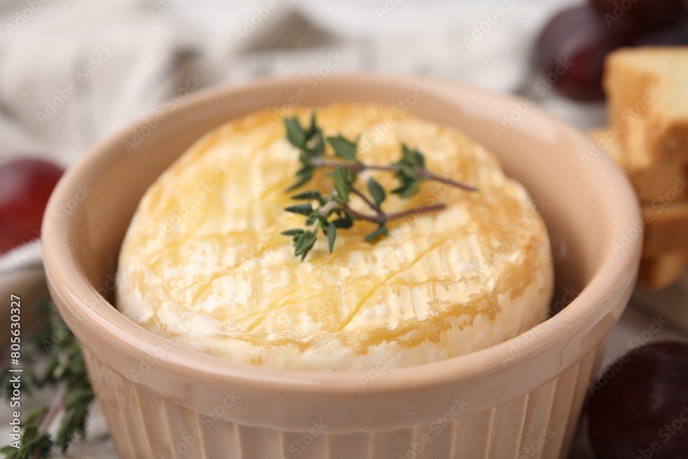 Tasty baked camembert in bowl on table, closeup Tasty baked camembert in bowl on table, closeup